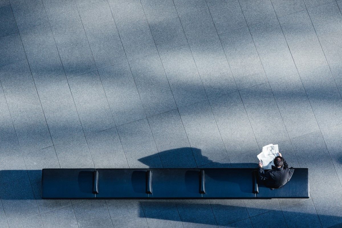 Man sitting reading newspaper